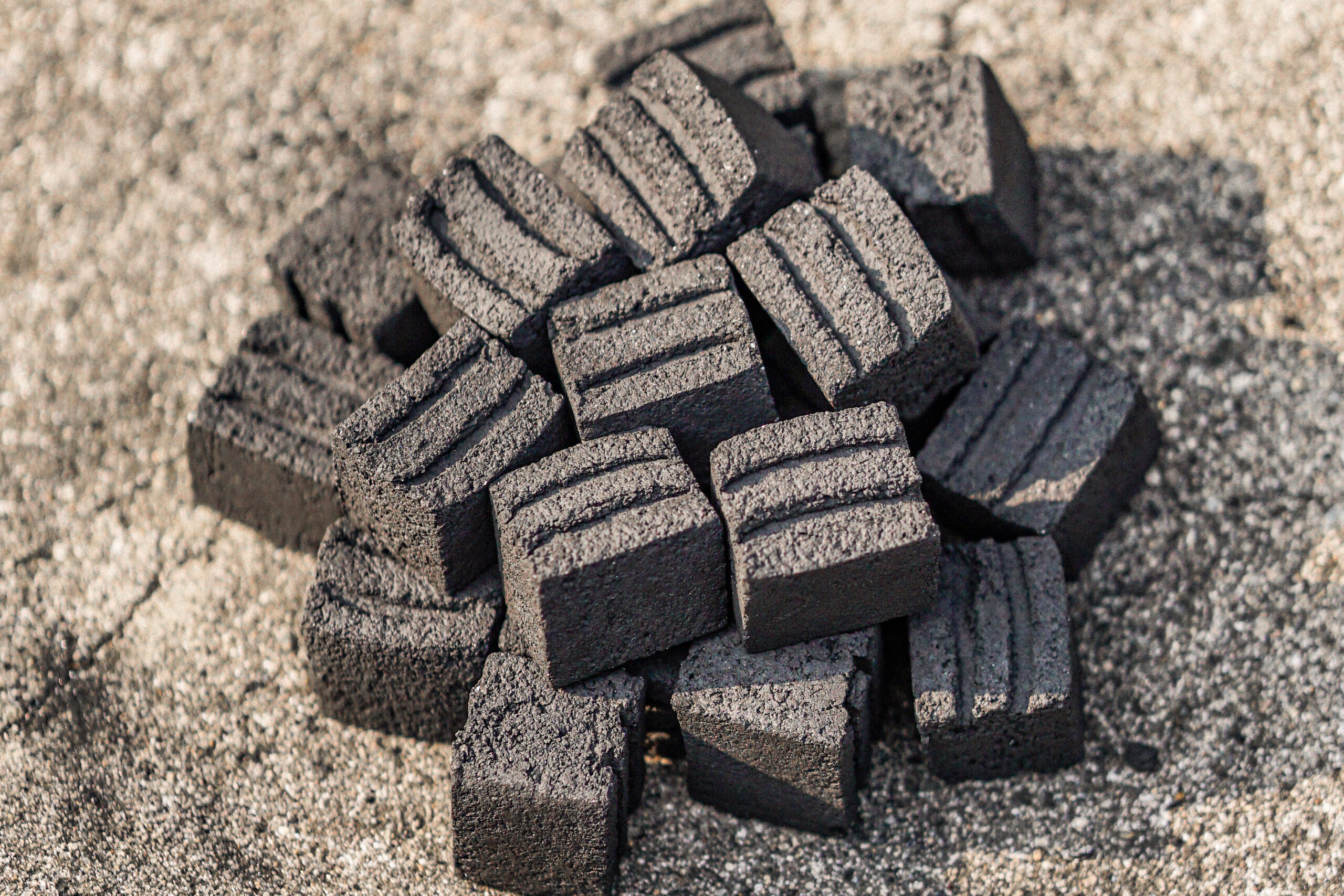 A Pile of Cube Two Lines Shaped Coconut Briquette Charcoals On The Ground