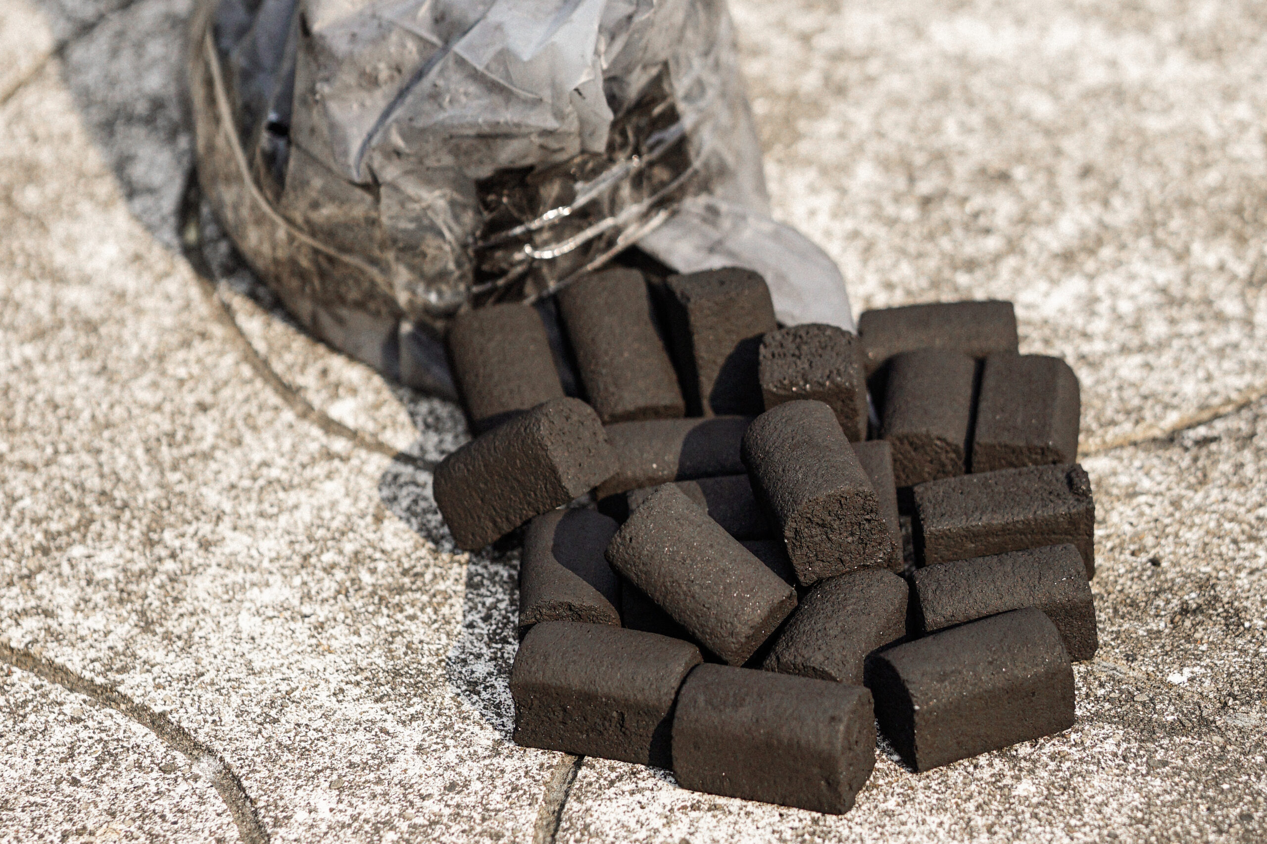A Pile of Half Finger Shaped Coconut Briquette Charcoal On The Ground
