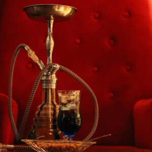 Hubbly Bubbly On Glass Table In Front of Red Sofa